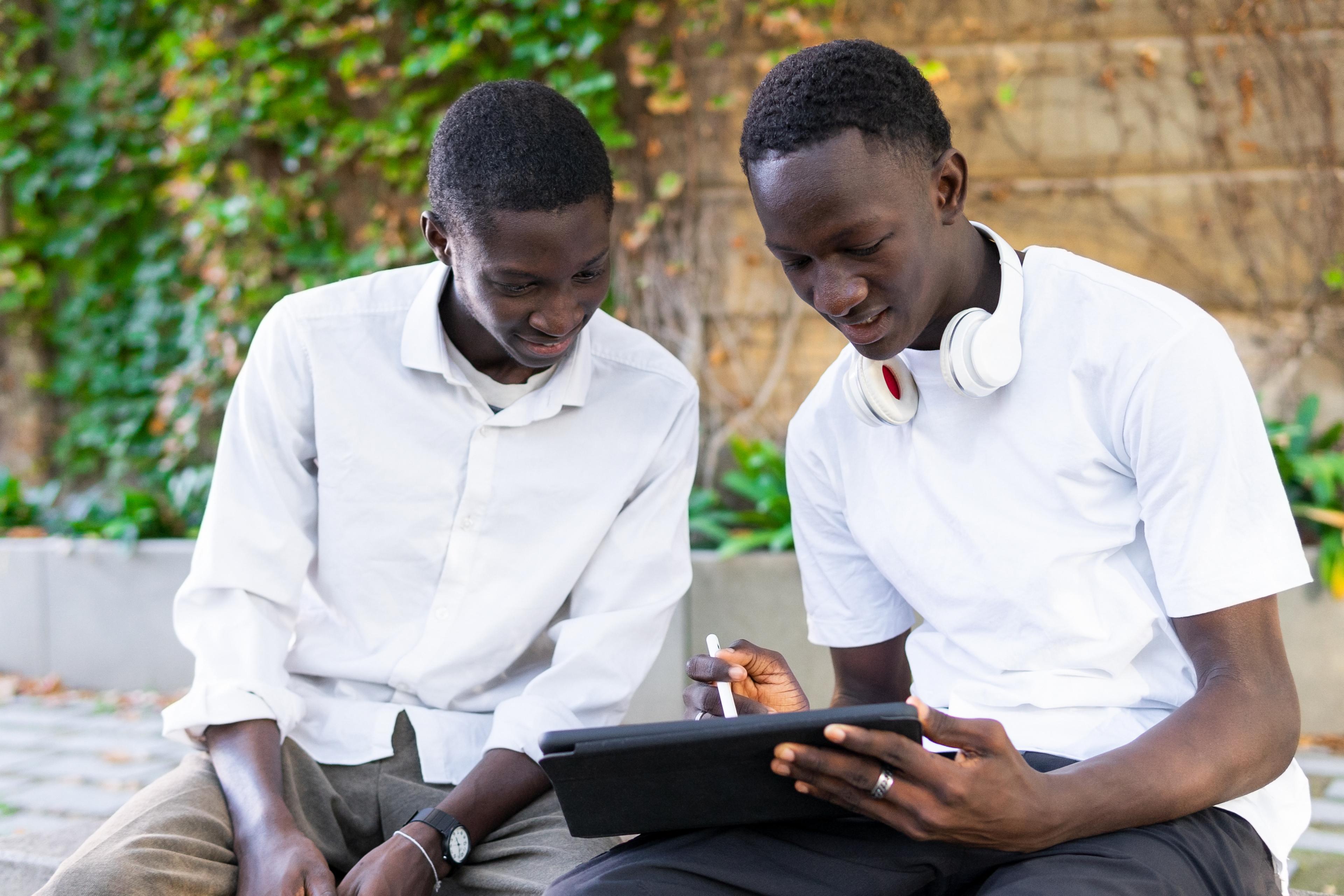 Students learning together on a tablet